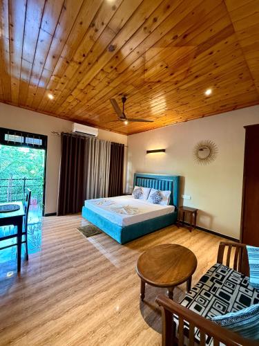 a bedroom with a bed and a wooden ceiling at Shan Star Weligama in Weligama