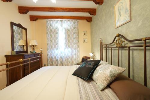 a bedroom with a large bed and a window at Villino AL CASTAGNO in SantʼAlfio