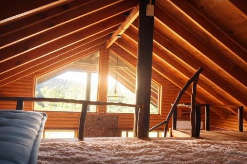 a room with a large window in a cabin at Cabaña Palafito in Coelemu