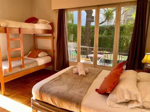 a bedroom with two bunk beds and a window at BbCasita Blue-Hostal in Santiago