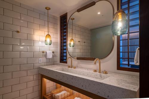 a bathroom with a large sink and a mirror at Hotel Indigo Bridgetown Barbados by IHG in Bridgetown
