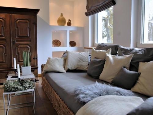 a living room with a couch with pillows on it at N7Quartier in Bad Münstereifel