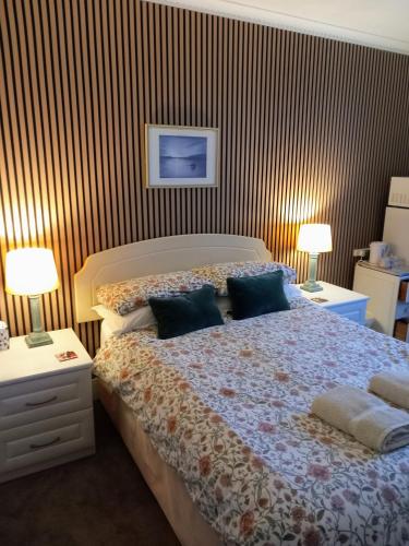 a bedroom with a bed with two pillows on it at Regis Lodge Guest House in Bognor Regis