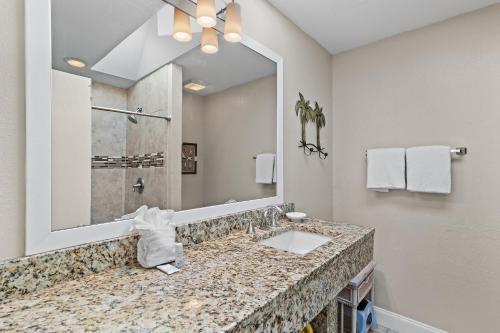 a bathroom with a sink and a large mirror at Sea-Esta in Destin