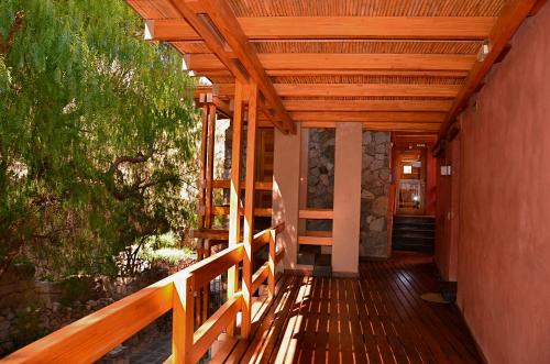 a wooden porch of a house with a wooden ceiling at Las Marías Hotel Boutique in Tilcara