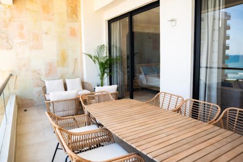 a wooden table and chairs on a patio at Departamento Cadiz in Miramar