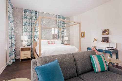 a living room with a couch and a bed at Lily Hall-A Boutique Hotel in Pensacola