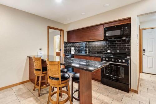 a kitchen with a counter and a stove top oven at Ground level Condo near Downtown Bend in Bend
