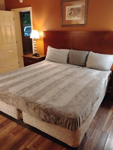 a bedroom with a large bed with a wooden headboard at Gated 1 King Bedroom 1 Bath Apt with Full Kitchen 129 in Baton Rouge