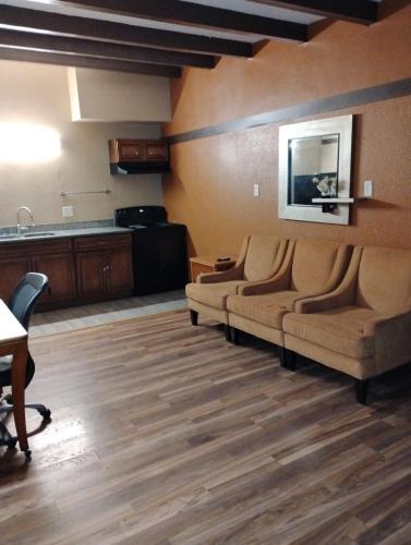 a living room with two couches and a kitchen at Gated 1 King Bedroom 1 Bath Apt with Full Kitchen 129 in Baton Rouge