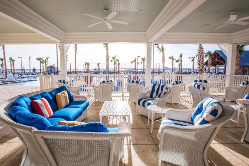 a patio with chairs and tables on the beach at The Beach Club at Charleston Harbor Resort and Marina in Charleston