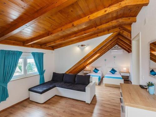 a living room with a couch and two beds at Villa Mis in Supetar
