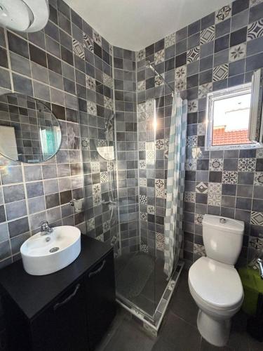 a bathroom with a toilet and a sink and a shower at Sweet home with a jard Slavica in Šušanj