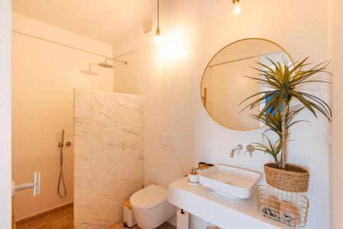 a bathroom with a sink and a mirror at Monte da Torre in Tavira