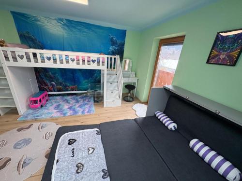 a bedroom with two bunk beds and an aquarium at Capybara Guest House in Spittal an der Drau
