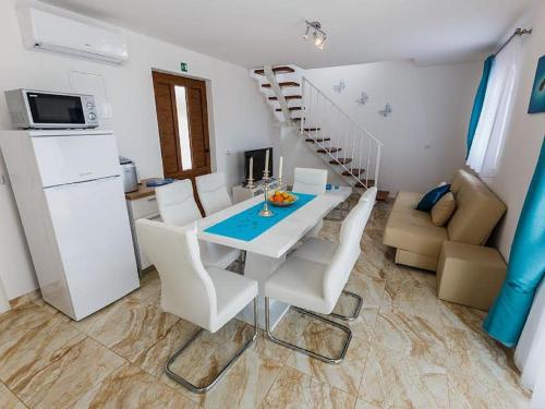 a kitchen and dining room with a table and chairs at Villa Mis in Supetar