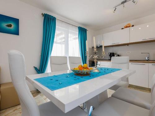 a kitchen with a table with a bowl of fruit on it at Villa Mis in Supetar