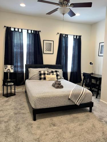 a bedroom with a bed and a ceiling fan at Cozy Home located in a prime area. in Philadelphia