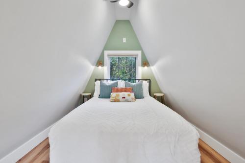 a bedroom with a white bed in a attic at Old Rag Mountain Getaway - WiFi, Smart TV, Fire Pit, Patio, & Full Kitchen in Etlan