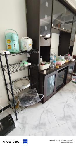 a room with a counter and a shelf with dishes at Mansion phram6 B in Bangkok