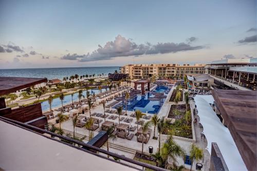 an aerial view of a resort with a pool and the ocean at Royalton Riviera Cancun, An Autograph Collection All-Inclusive Resort & Casino in Cancún