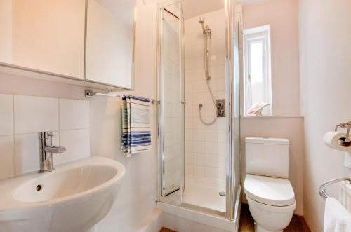 a bathroom with a sink and a toilet and a shower at 2 Bed in Southwold oc-hdanby in Southwold