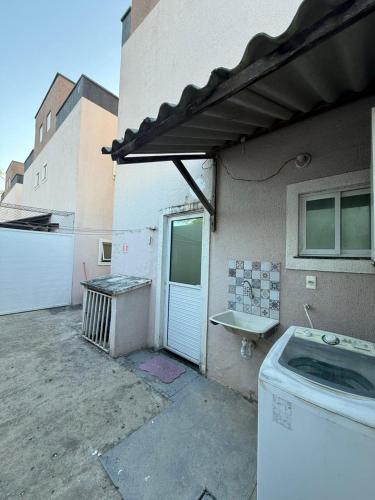 a washing machine sitting outside of a building at Diamond Summer in Caucaia
