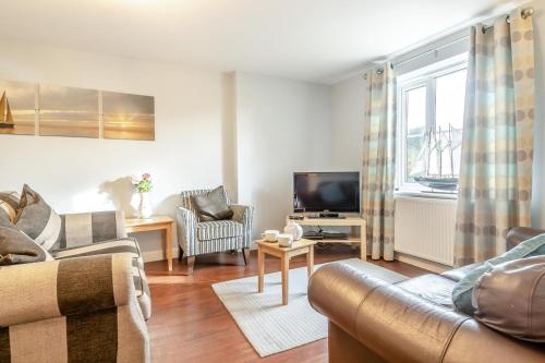 a living room with a couch and a tv at 3 Bed in Little Walsingham oc-1229 in Little Walsingham