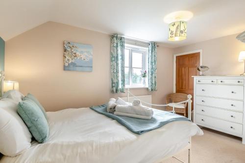 a bedroom with a white bed and a window at 3 Bed in Little Walsingham oc-1229 in Little Walsingham