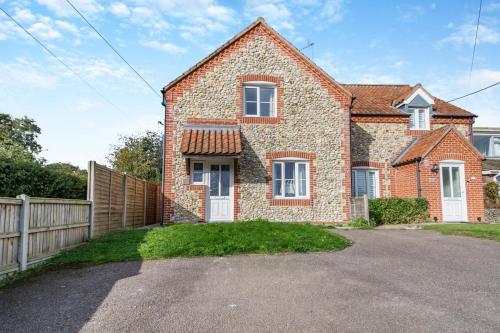 a brick house with a fence and a driveway at 3 Bed in Little Walsingham oc-1229 in Little Walsingham
