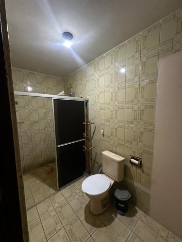 a bathroom with a toilet and a shower stall at 3R acomodações in Juazeiro do Norte