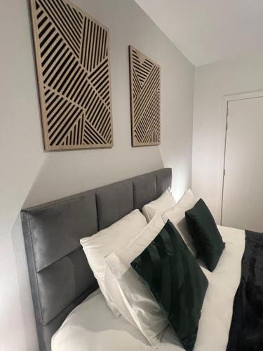 a bedroom with a bed with black and white pillows at Secret Garden 2 in Mellehoek