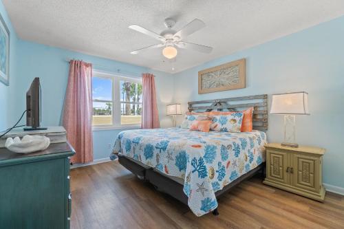 a bedroom with a bed and a tv and a window at Perdido Dunes 21 by Vacation Homes Collection in Orange Beach