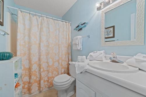 a bathroom with a sink and a toilet and a mirror at Perdido Dunes 21 by Vacation Homes Collection in Orange Beach