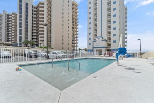 a swimming pool in a building with tall buildings at Perdido Dunes 21 by Vacation Homes Collection in Orange Beach