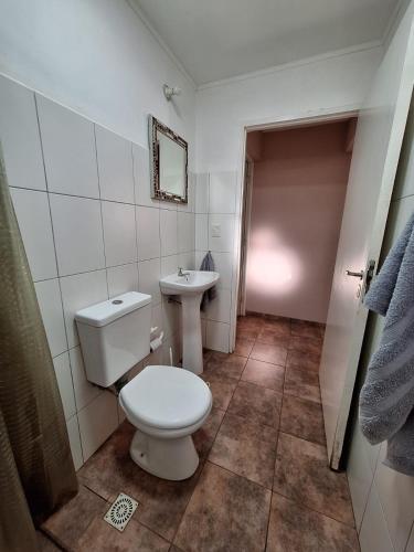 a white bathroom with a toilet and a sink at DaLi in Montecarlo
