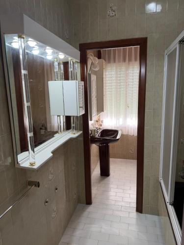 a bathroom with a sink and a mirror at Villa Laxes in Burela de Cabo