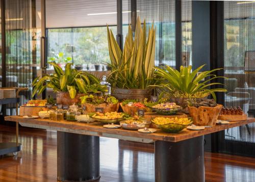 a buffet of food on a table with plants at Unique Garden in Mairiporã