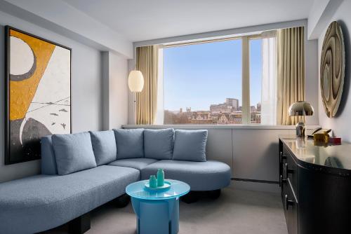 a living room with a couch and a large window at Sea Containers London in London