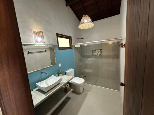 a bathroom with a sink and a toilet and a shower at Vila Sol Chalés in Pôrto de Pedras