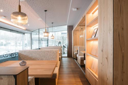 a dining room with a table and some chairs at Hotel Promenade in Bad Füssing