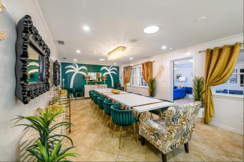 a dining room with a long table and chairs at Sleeps36 2Homes 12BR Heated Pool Spa Pickleball 14 Parking in Clearwater