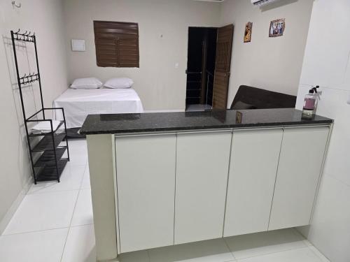 a kitchen with a counter in a room with a bed at Hotel Fazenda Arena Green in Cajazeiras