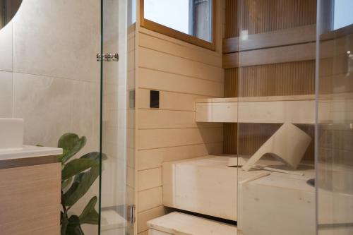 a bathroom with a glass shower and a sink at Levin Primus - Your Glass-Roof Gateway to Laplands Magic in Levi