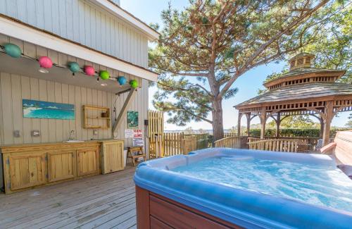 a hot tub on a deck with a gazebo at Doggone Perfect - Village at Nags Head, Soundfront, Golf Course View, Pool, Hot Tub, Pets OK, Flex Stays in Nags Head
