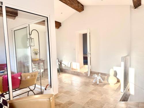 a living room with a couch and a mirror at La Villa au Patio Suspendu by GC - Clim - Wifi in Sérignan