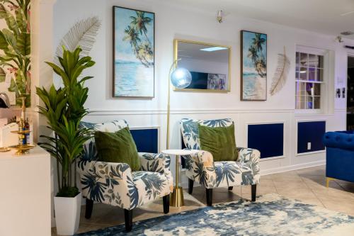 a living room with two chairs and a table at Sleeps36 2Homes 12BR Heated Pool Spa Pickleball 14 Parking in Clearwater