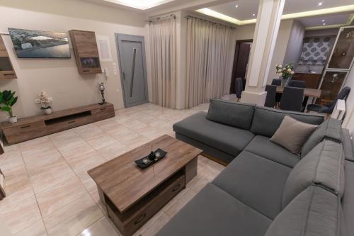 a living room with a couch and a coffee table at Efraim Oasis in Kos