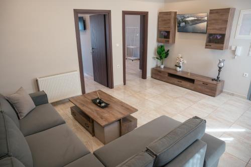 a living room with a couch and a table at Efraim Oasis in Kos