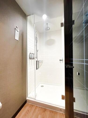 a shower with a glass door in a bathroom at AC Hotel By Marriott Salt Lake City Downtown in Salt Lake City